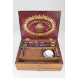 A 19th century Windsor and Newton mahogany artist's paint box, with fitted interior above a drawer