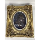 A bronzed oval plaque of a woman's profile on stone mount within gilt frame, 63cm by 52.5cm frame