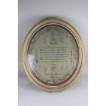 A framed George IV oval needlework sampler by Mary Ann Hemmings, dated 2nd Sept 1816, decorated with