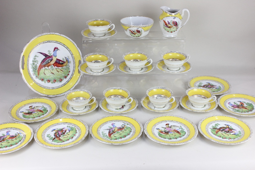 A Chelsea style porcelain part tea set, decorated with exotic birds within yellow borders and gilt