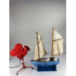 A scratch built model of a two-masted sailing boat, on blue painted stand, 54cm high including