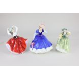 Three Royal Doulton porcelain figures of ladies, comprising 'Figure of the Year 1992 Mary', 'Karen',