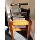 A 19th century cast iron and brass table top book press, mounted on a later wooden table, table