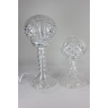 A cut glass table lamp, with glass base and globular glass shade, 45cm high, and another similar,