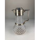 A silver plate mounted cut glass claret jug, with cast mask spout and engraved decoration (a/f)