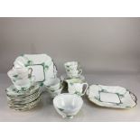 An Art Deco Fenton porcelain part tea service, comprising two cake plates, six cups, twelve saucers,
