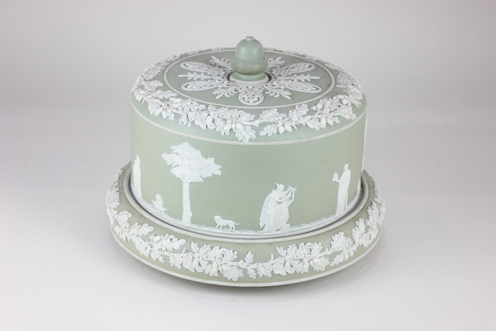 A 'Jasperware' green and white cheese dome and stand, decorated with relief applied classical