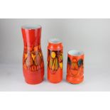 Three Poole pottery Delphis vases, with abstract decoration on orange ground, tallest 40.5cm high (