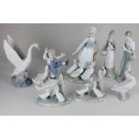 A Lladro porcelain figure of a girl holding a candle, 20cm, and two Nao porcelain figures of a