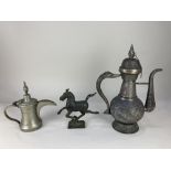 A large brass Arabic tea pot, with embossed design, a smaller coffee pot and a bronze model of a