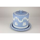 A Wedgwood Jasperware blue and white cheese dome and stand, decorated with relief applied