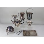 A silver plated three piece tea set, a rectangular wavy edged tray, an ice bucket with liner and