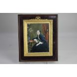 A 19th century miniature portrait of a lady dressed in blue velvet, seated beside a table, inscribed