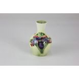 A Moorcroft pottery 'Orchid' pattern miniature vase, of baluster form, decorated with purple and