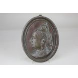 An oval cast metal profile plaque of Queen Victoria, verso marked Rd.68878, 25.5cm by 20.5cm