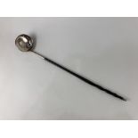 A toddy ladle, with George II 1758 shilling inset, whalebone handle, white metal unmarked