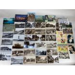 A small collection of black and white and colour postcards, including photographic views of