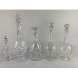 A pair of glass baluster shaped decanters, with diamond and swag decoration and three other