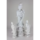 A group of three similar blanc de chine style standing figures, largest 50cm high (a/f)