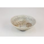 A studio pottery unglazed conical shallow bowl, probably Scandinavian, with swirling decoration to