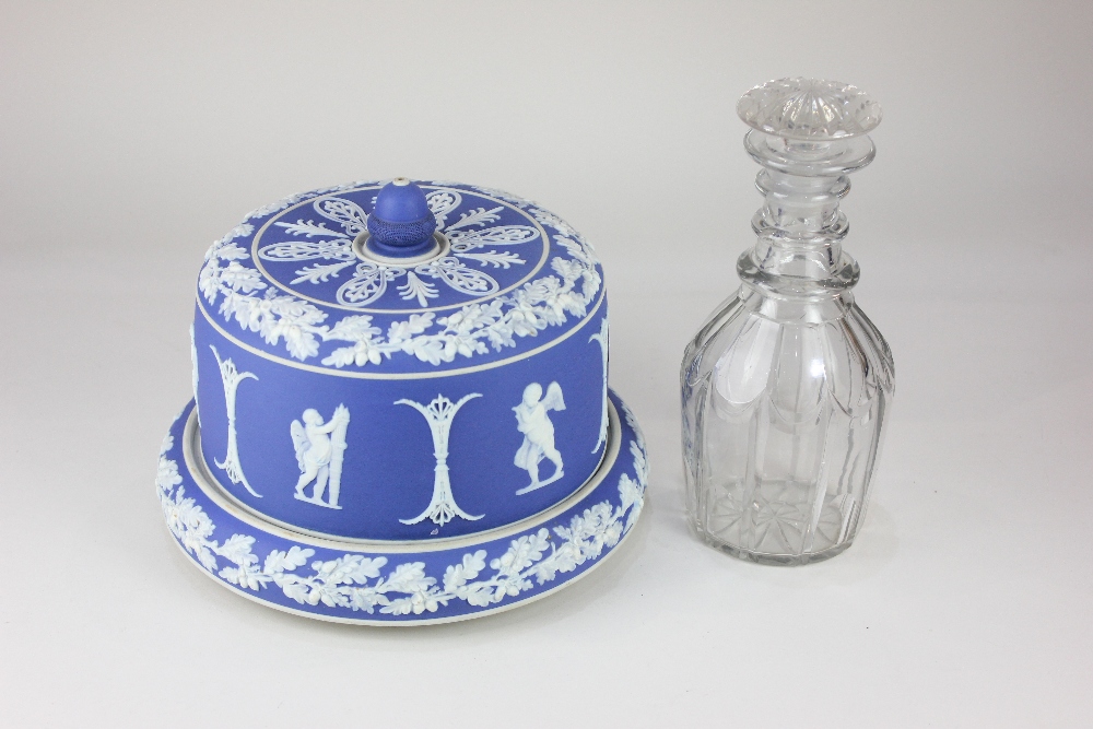 A 'Jasperware' blue and white cheese dome and stand, decorated with relief applied classical cherubs