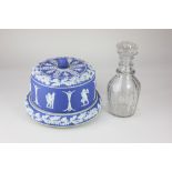 A 'Jasperware' blue and white cheese dome and stand, decorated with relief applied classical cherubs