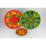 Two Poole pottery chargers, to include one decorated with a pattern on green ground, 35cm,