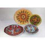 A Poole pottery Aegean oval dish and plate, each decorated with a linear pattern on speckled ground,