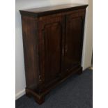 An early 19th century mahogany side cabinet with two crossbanded panelled doors with line inlay,