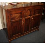 An early 19th century mahogany cupboard with two panelled doors enclosing shelves on splayed bracket