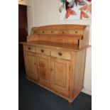 A pine farmhouse kitchen style sideboard, raised shelf back with five drawers, rectangular top