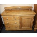 A pine sideboard, with raised shelf back, three drawers with knob handles and cupboard, on turned