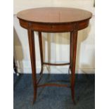 A George III Sheraton style inlaid mahogany work table with crossbanded oval top enclosing red paper