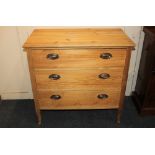 A pine chest of three drawers, with oval brass plate handles, on slender shaped legs, 85cm