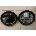 A pair of oak and gilt framed oval wall mirrors, mirror plate 36cm by 43cm