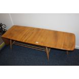 An Ercol pale wood drop flap coffee table, rounded rectangular top, with two end drop flaps, with