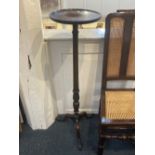 A mahogany jardiniere stand on fluted baluster stem and tripod base with carved paw feet, 106cm