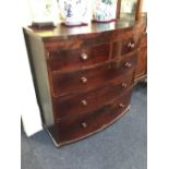 A Victorian mahogany bow front chest of two short over two long drawers, with turned knob handles,