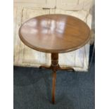 A 19th century mahogany circular occasional table with tilt top on turned support and tripod base (