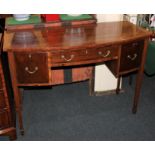 A Sheraton style mahogany bowfront side table, central drawer flanked by two cupboards on square