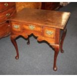 A George III oak lowboy, with three drawers, fret cut kneehole on cabriole legs and pad feet 76cm