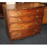 A George III mahogany bowfront chest of four graduated drawers with oval brass drop handles, on