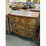 An early 19th century mahogany bow front chest of two short and two long drawers, on bracket feet,
