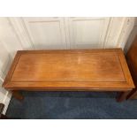 A Chinese teak coffee table with rectangular panelled top, on square legs, 127cm
