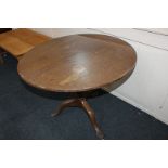 A George III mahogany tea table with circular top, birdcage support and pedestal tripod base, 91cm