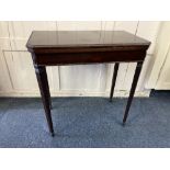 A mahogany rectangular card table with finely carved border and fold over top with green baise