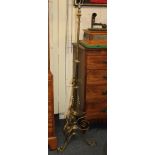A brass standard lamp, with extendable column on three scroll feet, 173cm high fully extended