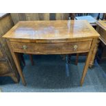 A George III walnut bow front side table with rosewood cross banding, frieze drawer, on square