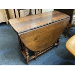 An 18th century oak gate leg dining table on turned and block legs, 142cm open