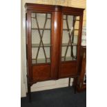 An Edwardian inlaid mahogany display cabinet, with twin panelled glazed doors, (one damaged)